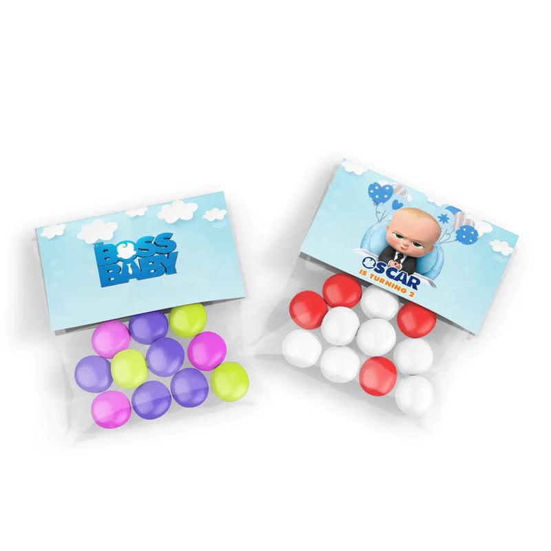 The Boss Baby treat bag topper label folded over clear bag filled with candies and sealed with staple
