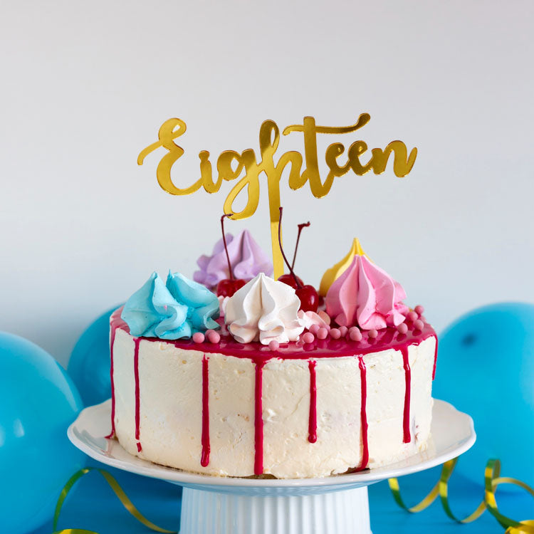 Gold acrylic cake topper with the text 'eighteen,' perfect for 18th birthday celebrations.