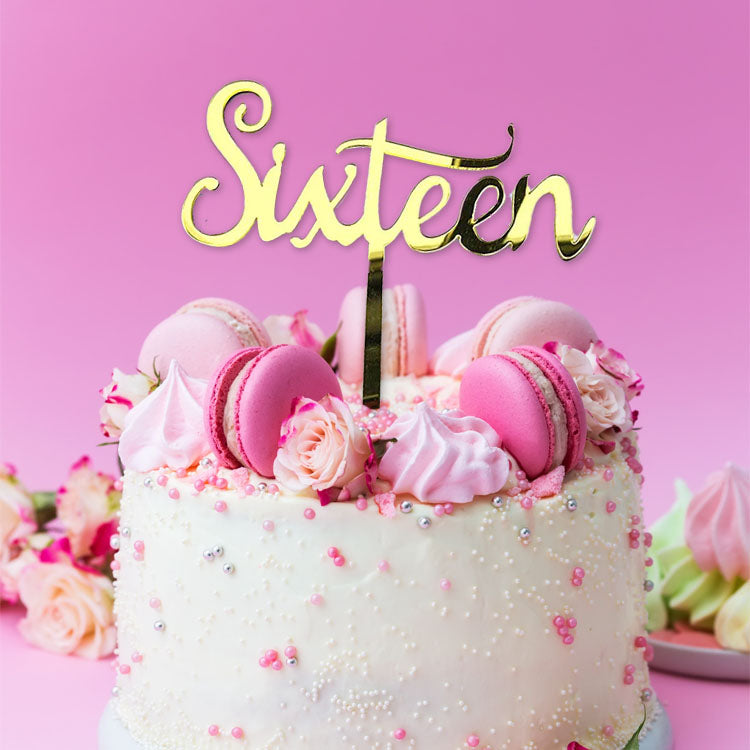 Gold acrylic cake topper with the text 'sixteen,' perfect for 16th birthday celebrations.