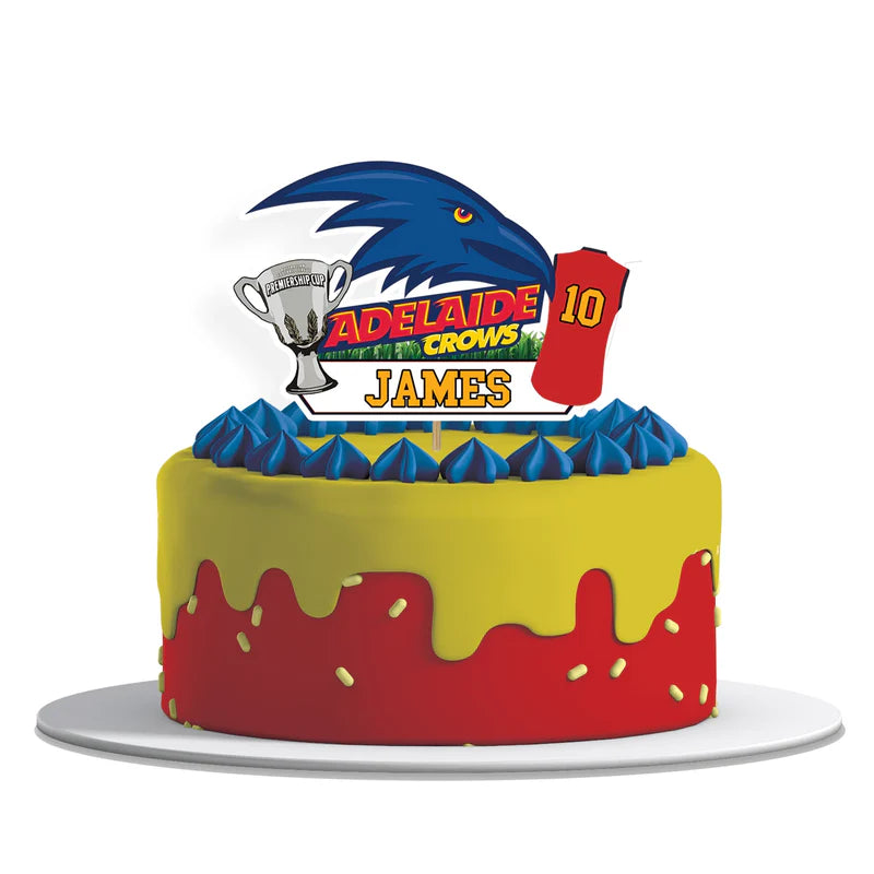 Adelaide Crows cake toppers with bold logo cutouts in team colors on flat lay white surface