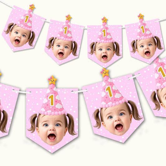 Baby pink kids party bunting banner hanging on a wall with personalised child face photo cutouts and custom birthday text.