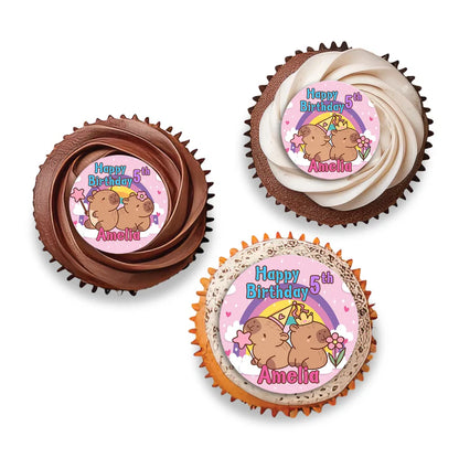 Capybara personalized cupcake toppers shown as small round themed decorations on wooden sticks flat lay