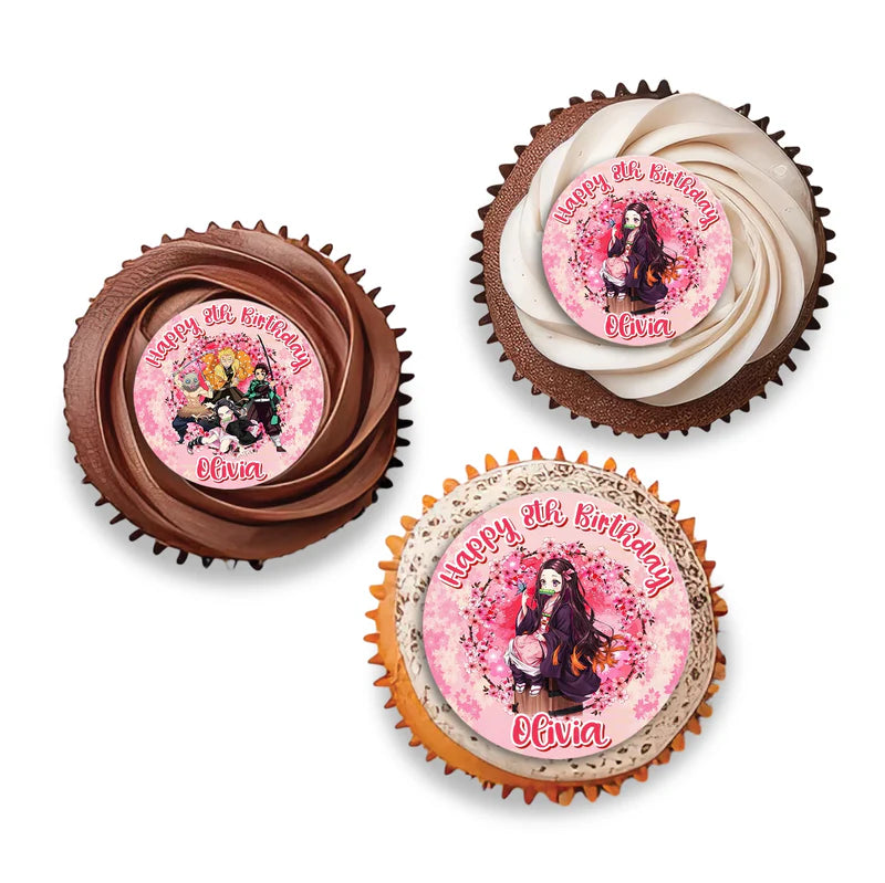 Demon Slayer Nezuko cupcake toppers with names and pink bamboo patterns arranged on frosted treats