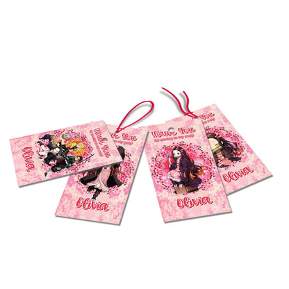 Demon Slayer Nezuko thank you tags featuring pink checkered borders and text on a white table flat lay