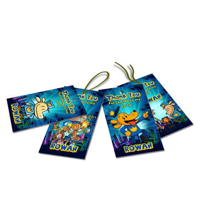 Dog Man thank you tags with colorful text accents displayed on a neatly wrapped party favor box