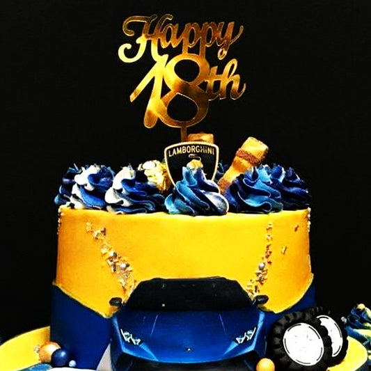 Gold acrylic cake topper shaped as 'happy 18th' for a milestone birthday celebration cake