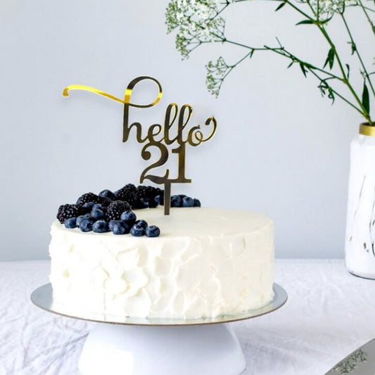 Gold acrylic cake topper with the text 'Hello 21,' perfect for 21st birthday celebrations.