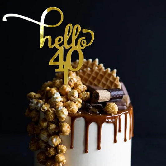 Gold acrylic cake topper shaped as 'hello 40' for a milestone birthday celebration cake