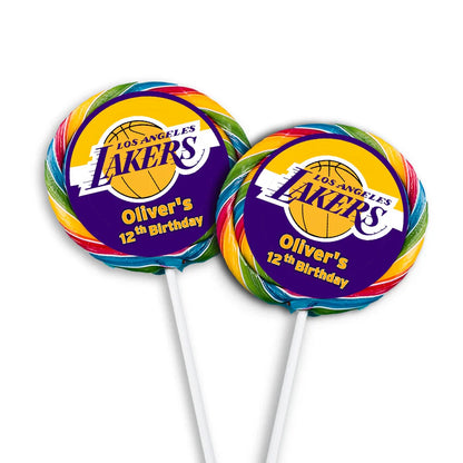 LA Lakers lollipop label with round purple and gold design applied to white lollipops in row