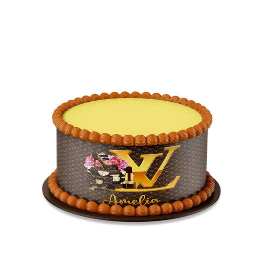 Louis Vuitton inspired edible cake strips with brown gold monogram wrap on frosted cake flat lay
