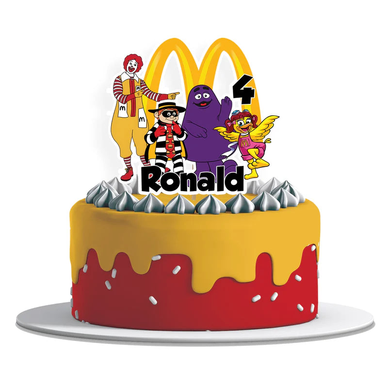 McDonalds cake toppers featuring red background and yellow arches arranged on wood surface