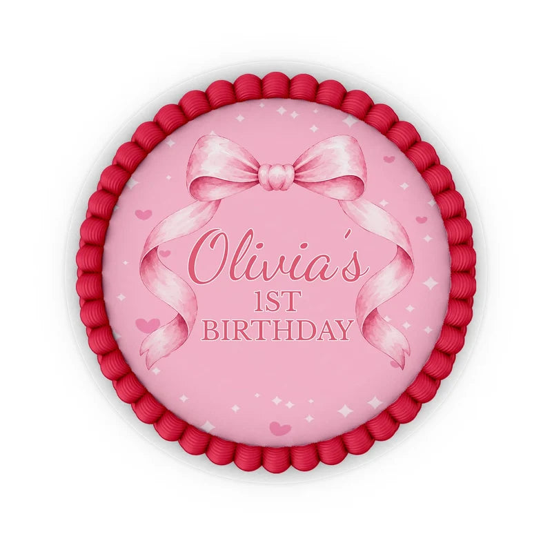 Pink Bow edible icing cake images with soft pink ribbon accents placed on a frosted round cake