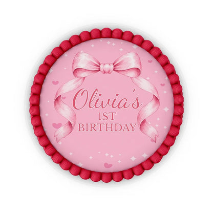 Pink Bow edible icing cake images with soft pink ribbon accents placed on a frosted round cake