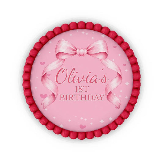 Pink Bow edible icing cake images with soft pink ribbon accents placed on a frosted round cake