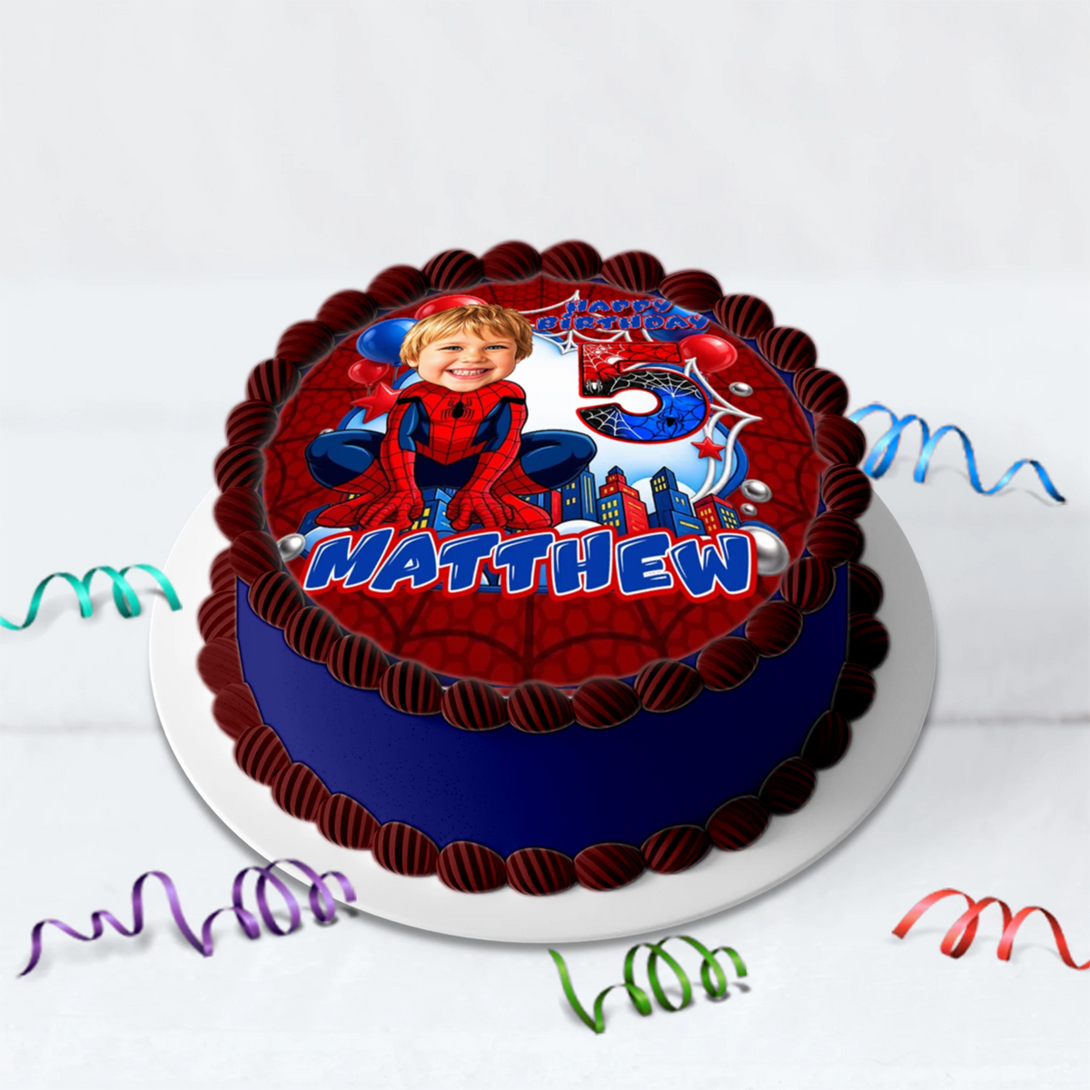 Printed edible icing cake topper sheet with a Spider-Man theme, featuring a customized kid's face drawn in a cartoon caricature style with custom name and age.