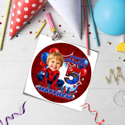 Printed edible icing cake topper sheet with a Spider-Man theme, featuring a customized kid's face drawn in a cartoon caricature style with custom name and age.