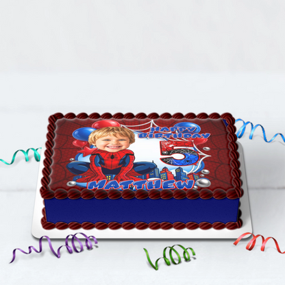 Printed edible icing cake topper sheet with a Spider-Man theme, featuring a customized kid's face drawn in a cartoon caricature style with custom name and age.