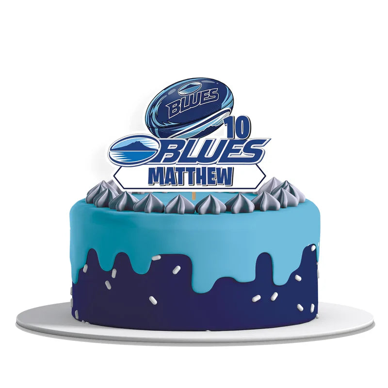 The Blues Rugby personalized cake toppers with custom text and a rugby ball cutout design on a clean white background.