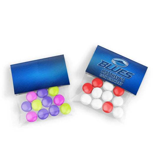 The Blues Rugby treat bag topper label folded neatly over clear cellophane party favors filled with team blue candy drops.