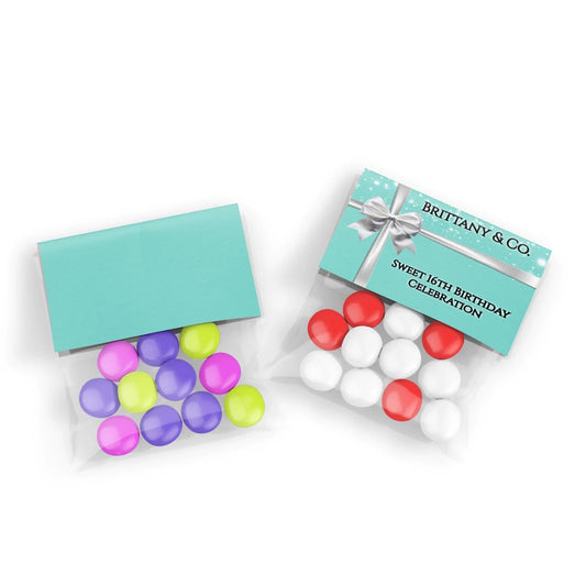 Tiffany & CO treat bag topper label with white ribbon graphics and custom name on a teal blue flat lay