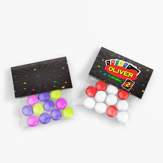 Uno treat bag topper label folded over clear treat bag, bold Uno design, custom message visible, flat lay