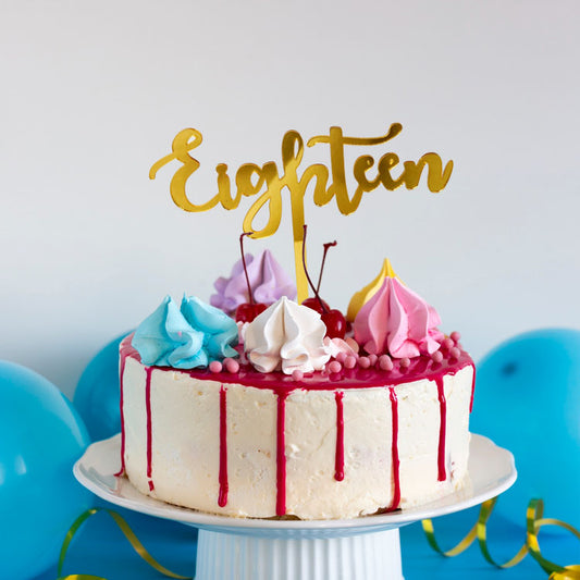Gold acrylic cake topper shaped as '18' 'eighteen' for a milestone birthday celebration cake