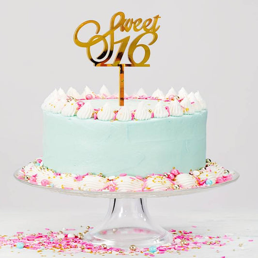 Gold acrylic cake topper shaped as 'sweet 16' for a milestone birthday celebration cake